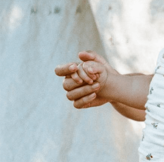 Mother holding baby's hand